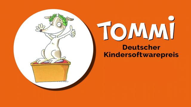 TOMMi – Deutscher Kindersoftwarepreis TOMMi – Deutscher Kindersoftwarepreis. Ein Hund auf einem Treppchen mit Daumen nach oben